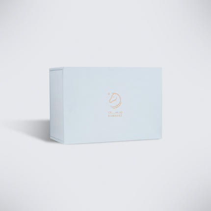 Closed pale blue Al Abiad Set box on warm grey backdrop, kids perfume gift set